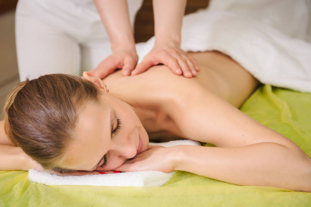 woman enjoying classical neck and shoulder massage
